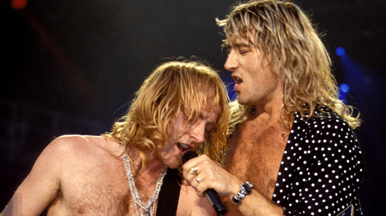 Def Leppard performing onstage in the 1980s