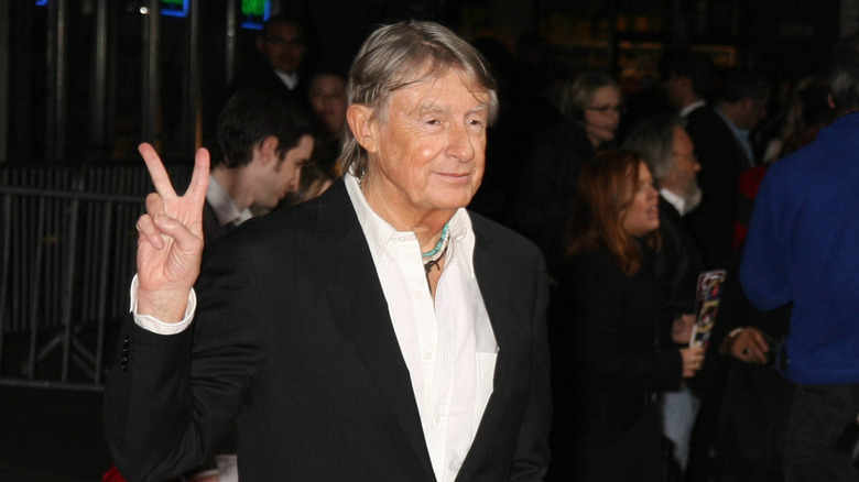 Joel Schumacher showing the peace sign