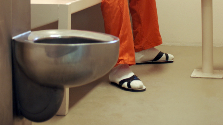 prisoner sitting in empty cell