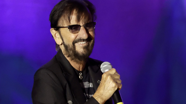 Ringo Starr holding a microphone