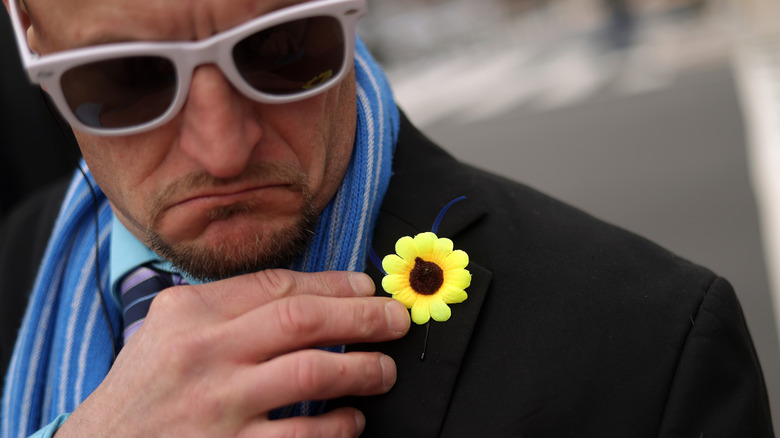 Demonstrator with sunflower pin