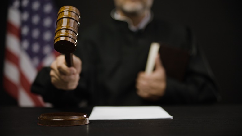 judge hitting a gavel american flag