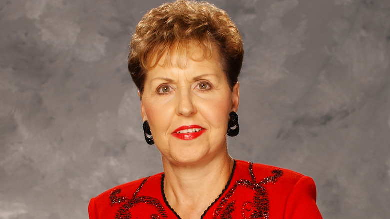 Joyce Meyer in red jacket staring into camera