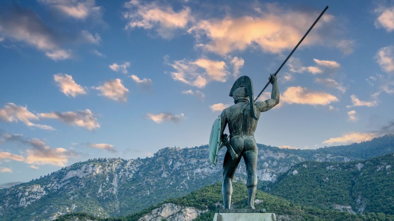 Bronze statue Spartan shield spear mountains