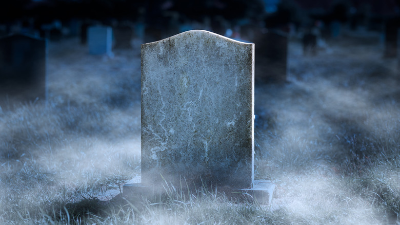 blank gravestone in foggy cemetery