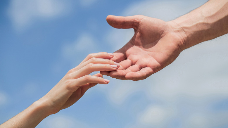 hands reaching out to each other