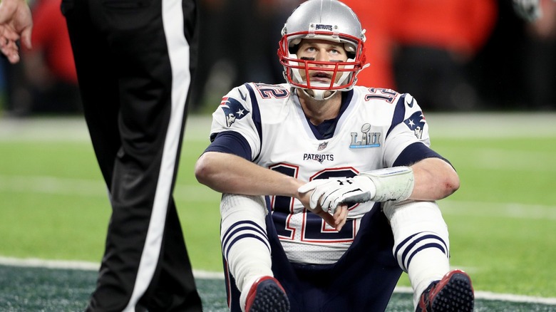 Tom Brady sitting on field