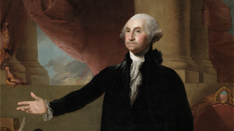 washington black suit white collar arm outstretched