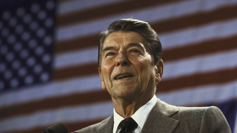 reagan speech suit tie flag background