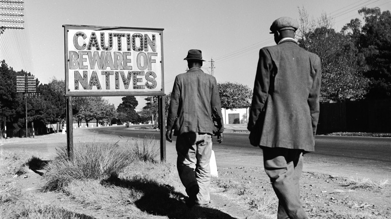 sign common in Johannesburg, South Africa, reading 'Caution Beware Of Natives'. 