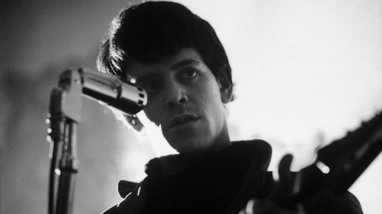 Lou Reed with guitar at microphone