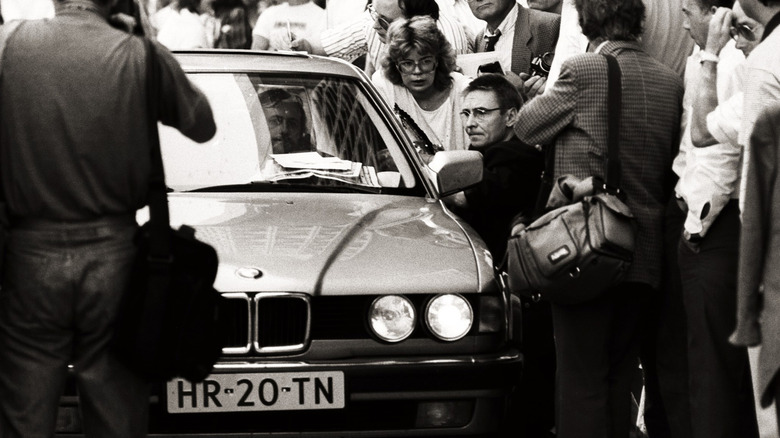 Glackbeck getaway car surrounded by journalists