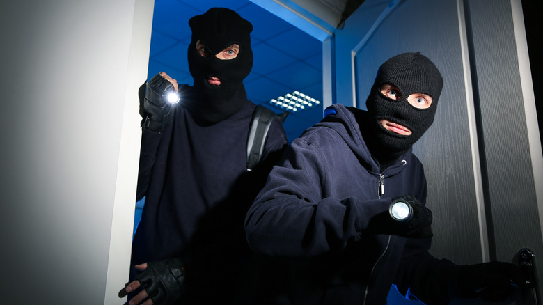 Masked thieves sneaking into building
