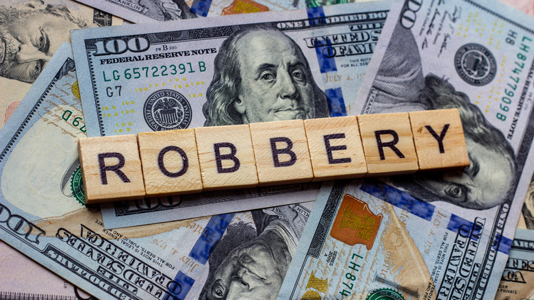 money and blocks spelling "robbery"