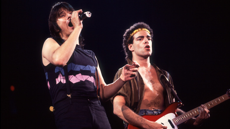Steve Perry and Neal Schon performing on stage.