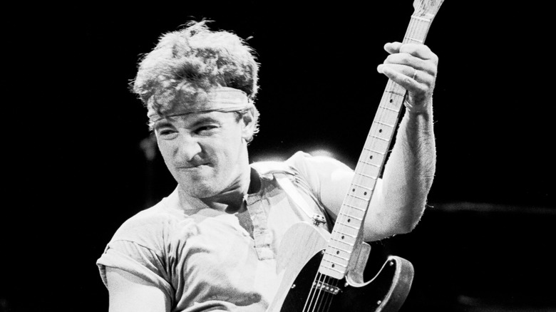 Bruce Springsteen playing guitar in bandana