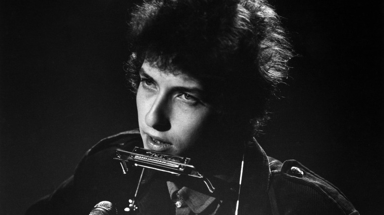 Bob Dylan with harmonica on frame