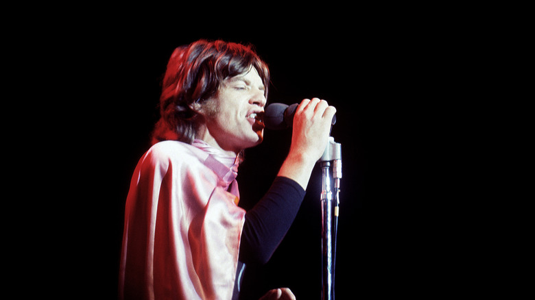 Mick Jagger singing into a microphone during a Rolling Stones concert