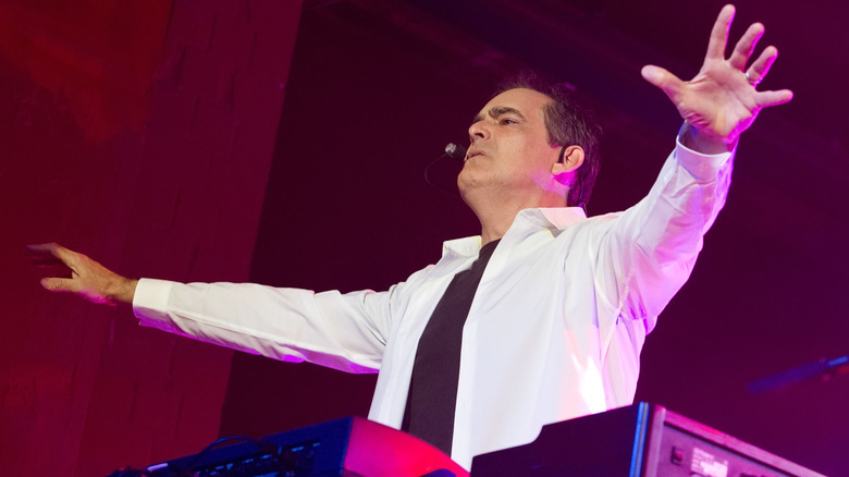 Neal Morse performing live with hands out