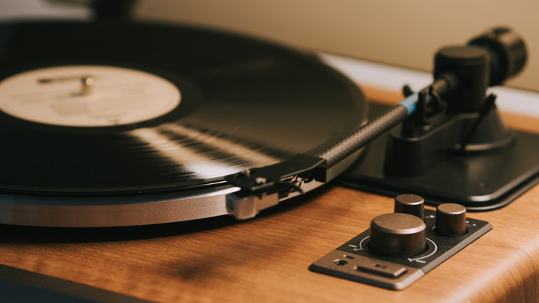 record player with wooden base and open lid