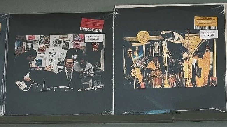 Two copies of Sun City Girls albums next to each other on a wall.