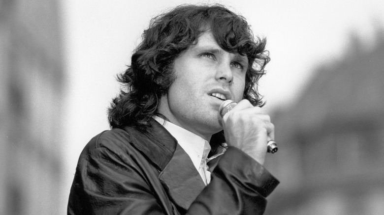 Jim Morrison singing on stage.