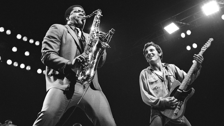 Clarence Clemons and Bruce Springsteen performing on stage.