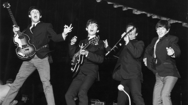 The Beatles jumping around on stage