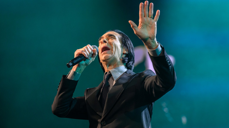 sad woman with headphones on in bed holding pillow