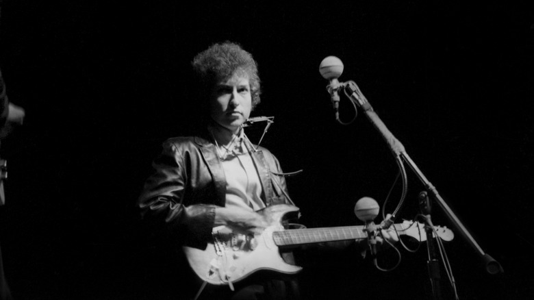 Bob Dylan plays electric guitar at the 1965 Newport Folk Festival