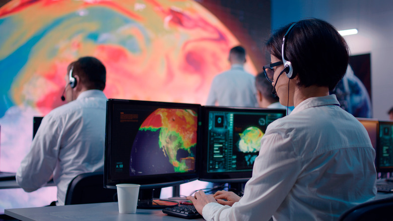 people at computers looking at Earth