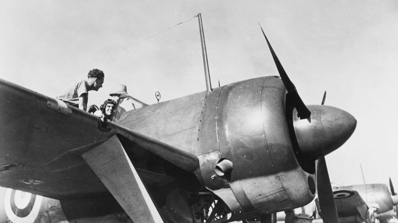 Pilot seated and man on the wing of a Brewster F2A Buffalo