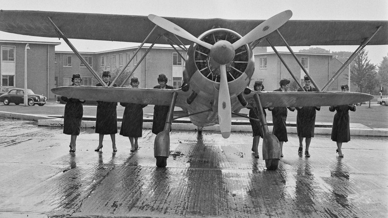 women pushing CR.42 Falco