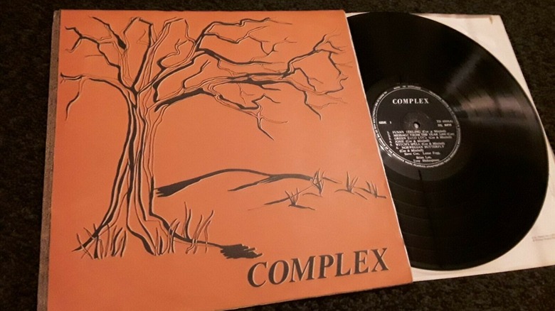 Complex album cover with illustration of tree