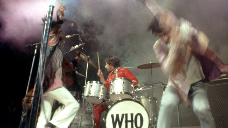 The Who playing on stage and running around