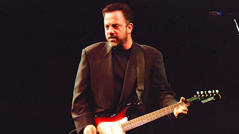 Billy Joel playing a guitar circa the '80s