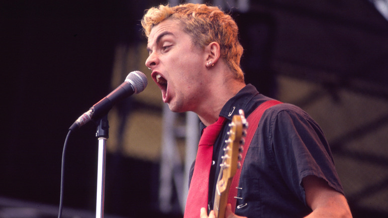 Green Day's Billie Joe Armstrong screaming into a microphone in 1994