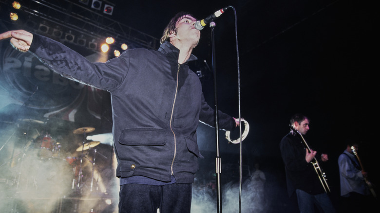 Oasis performing on stage in 1994