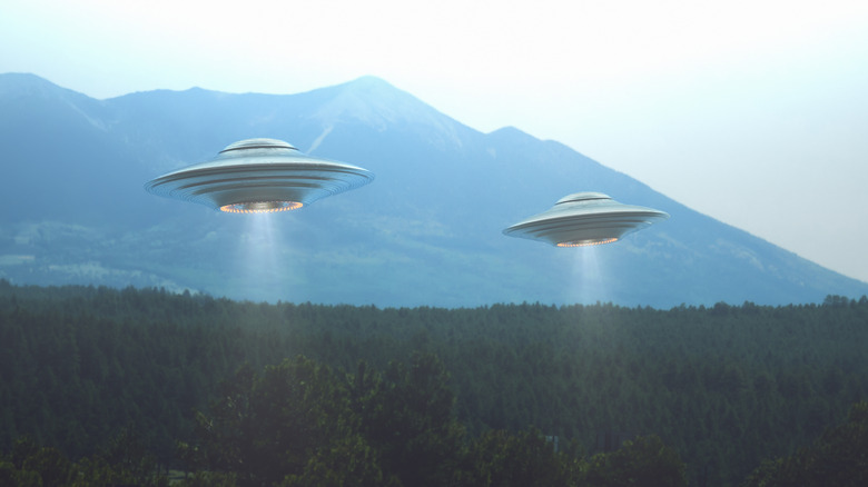 Two UFOs over trees