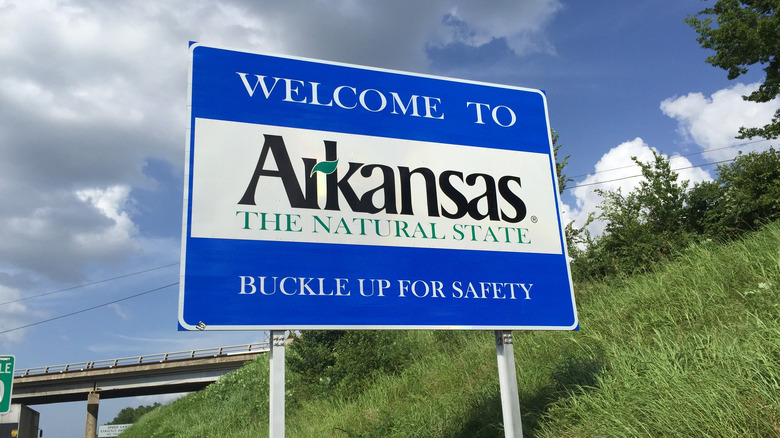 a sign welcomes visitors to arkansas