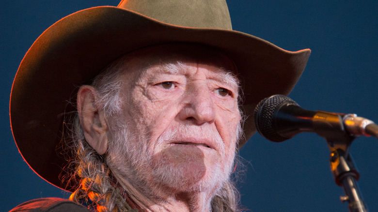 Willie Nelson performing in a cowboy hat