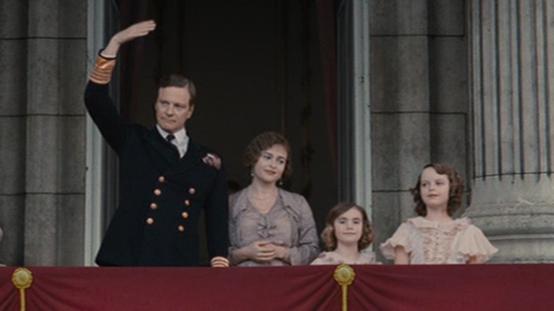 King George VI (Colin Firth) waving with family on balcony