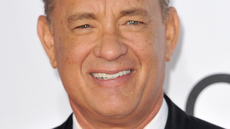 Tom Hanks smiles for cameras