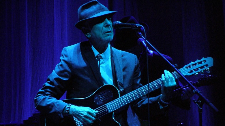 Leonard Cohen performing on stage