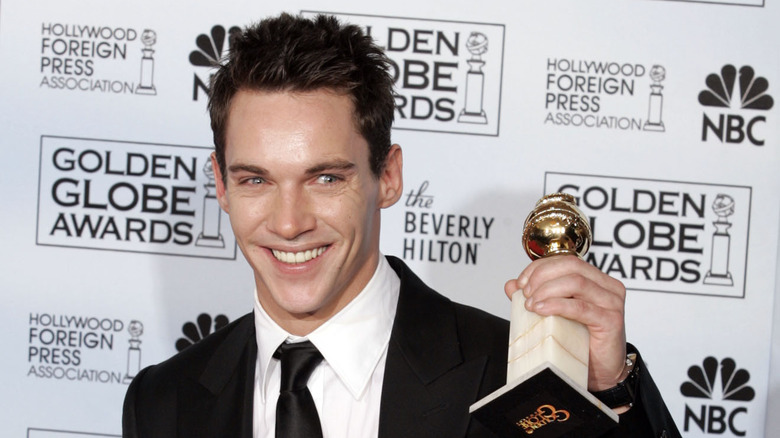 Jonathan Rhys Myers holds up his Golden Globe for "Elvis: The Early Years"