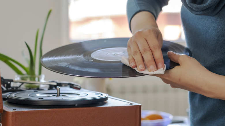 Someone cleaning a vinyl record