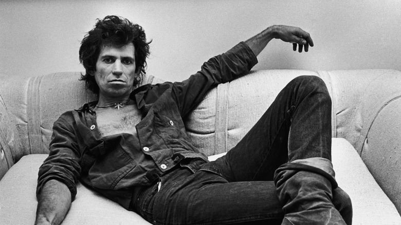 Keith Richards in middle age posing on a couch