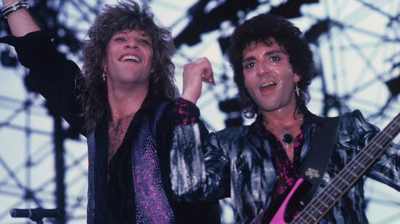 Jon Bon Jovi and Alec John Such performing on stage.