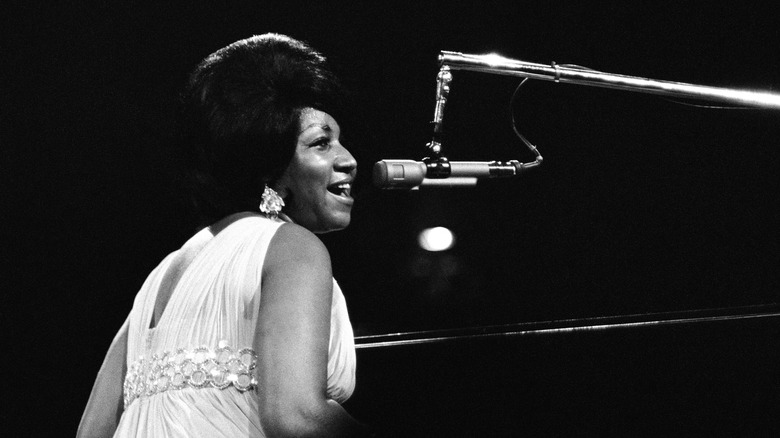 Aretha Franklin singing while sitting at piano