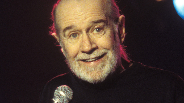 george carlin on stage at a comedy club